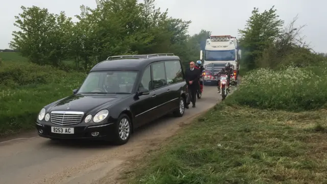 Hearse and HGV on country lane