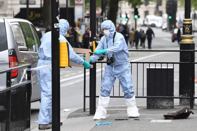 Forensic officers handling a knife