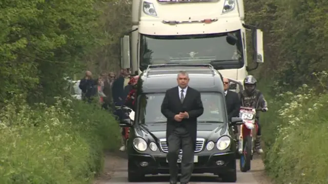 Funeral cortege and lorry