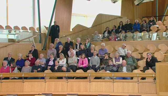 Campaigners watch on from the gallery