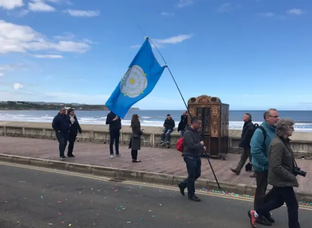 Man carrying Yorkshire flag in Scarborough