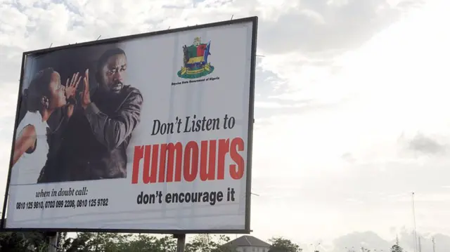 A state billboard displayed along the road campaigning against rumour mongering in Yenagoa, Nigeria's southern Bayelsa State