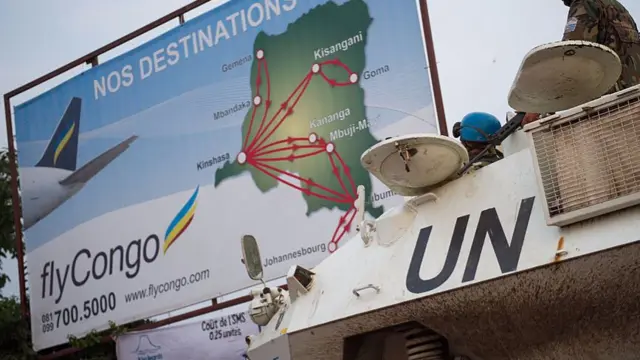 United Nations peacekeepers stand deployed with an armoured personnel carrier (APC) in the eastern city of Goma