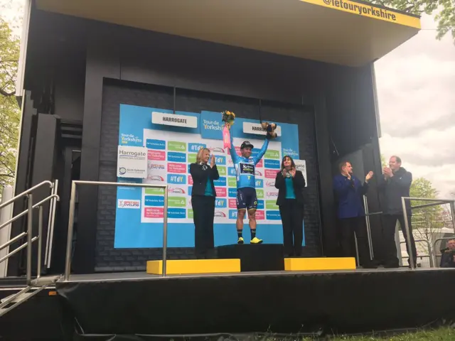 Caleb Ewan new race leader receiving his jersey