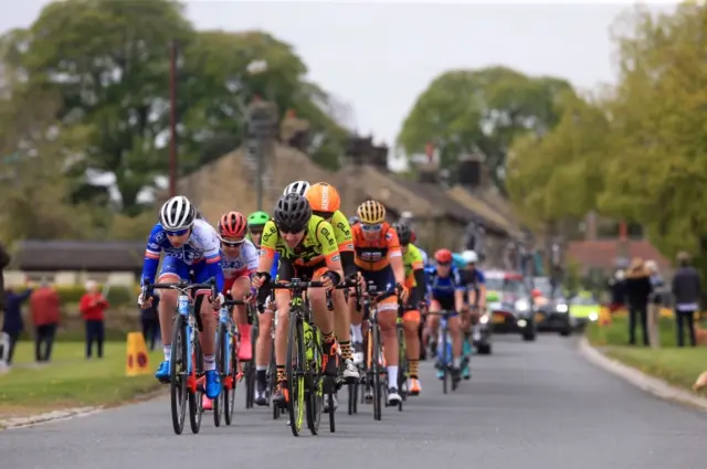 The peloton passes through Tadcaster during the Women"s race of the Tour de Yorkshire