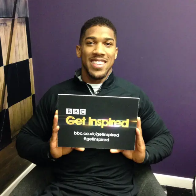 Anthony Joshua holding a BBC Get Inspired card