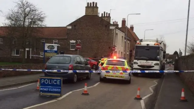 Police cars and bin lorry and other car