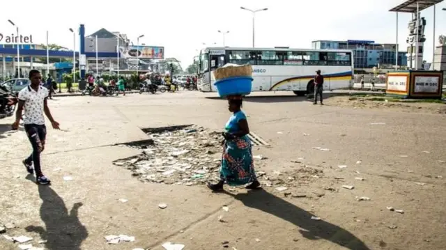 
          People walk in an empty street in Kinshasa on April 3, 2017 during a general strike called by the opposition
        