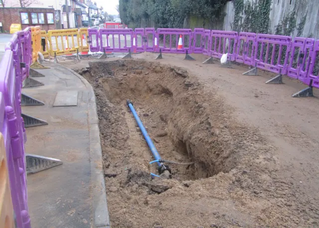 Hole in the road on The Street, Holbrook