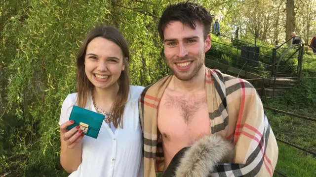 Girl holding her bag alongside the man