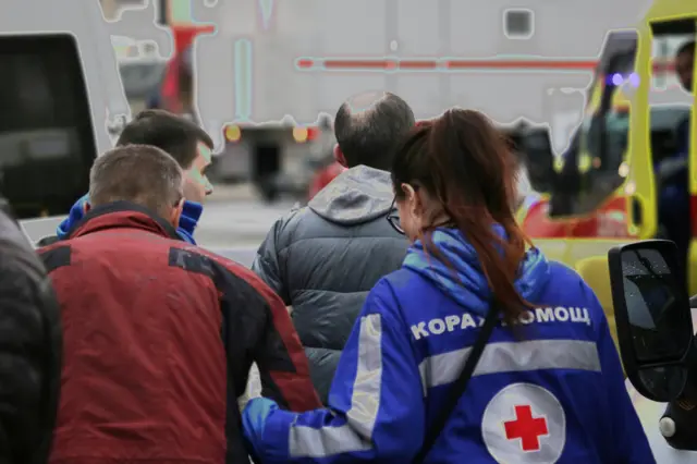 
          An injured person is helped by emergency services outside Sennaya Ploshchad metro station following explosions in St. Petersburg
        