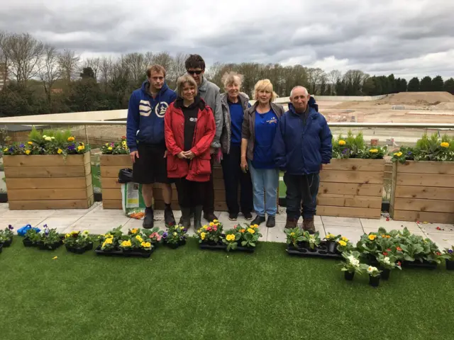 Helpers preparing a garden