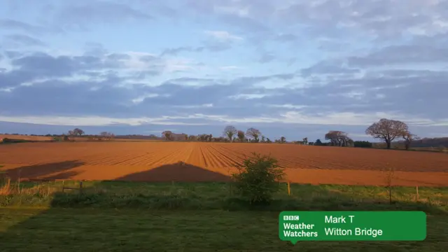 Grey clouds over ploughed fields