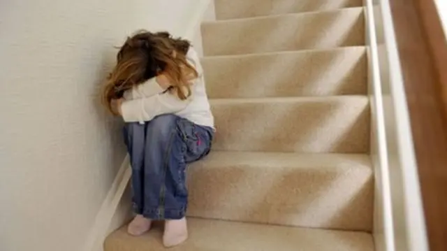Girl hiding on stairs
