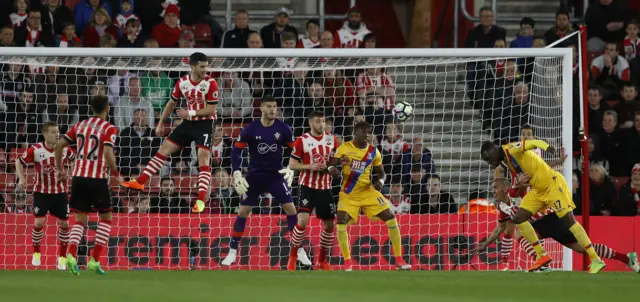 Christian Benteke heads on goal