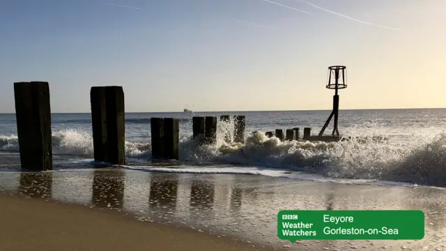 Waves crashing onto sandy beach