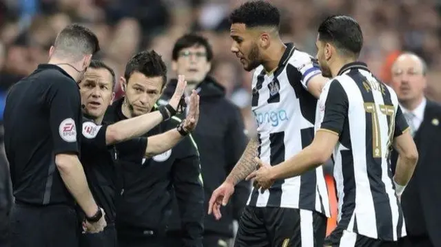 
          Newcastle players protesting following Keith Stroud's decision to rule out Matt Ritchie's penalty
        