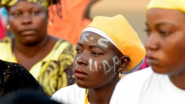 Woman with UDP painted on her face