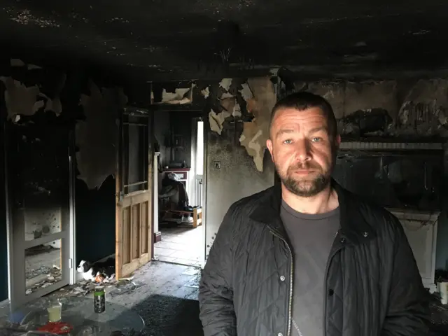 Martin Chapman in the fire-damaged house