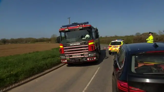 Fire engine and police vehicles near scene of accident