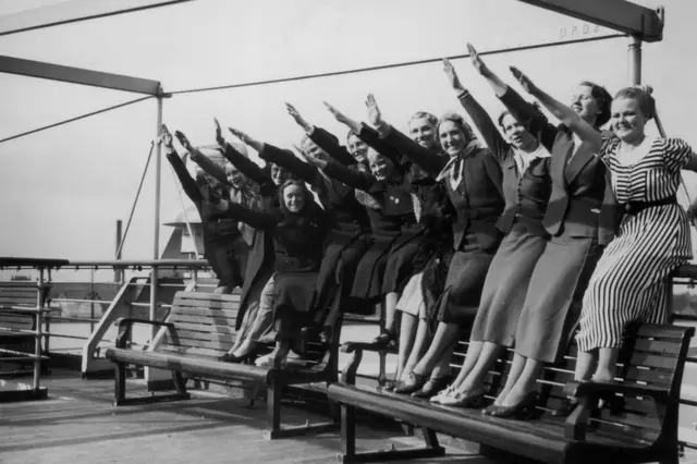 
          A group of women at Tilbury photographed giving the Nazi salute on the deck of the Wilhelm Gustloff
        