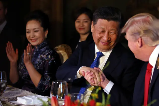 Chinese President Xi Jinping shakes Mr Trumps hand