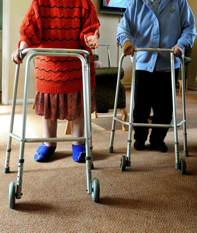 Two women using walking frames