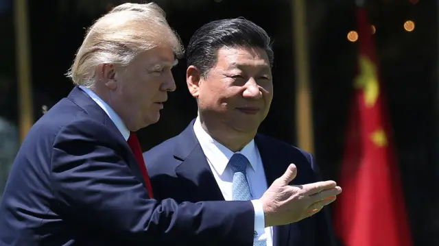 
          U.S. President Donald Trump and China"s President Xi Jinping chat as they walk along the front patio of the Mar-a-Lago estate after a bilateral meeting in Palm Beach
        