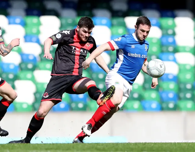 Philip Lowry in action against Jamie Mulgrew of Linfield