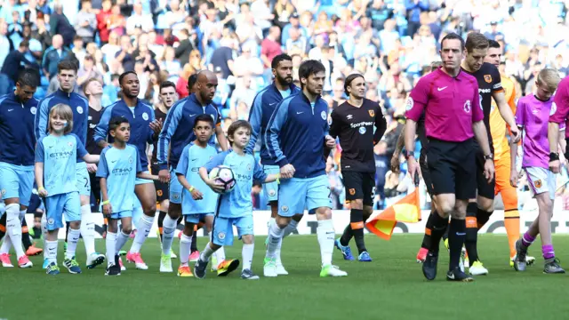 David Silva leads the teams out