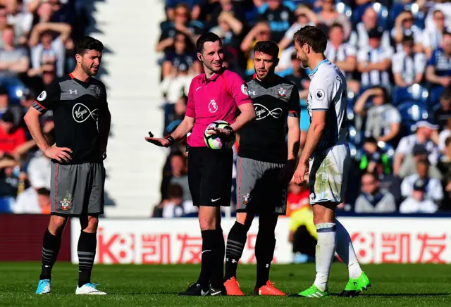 Referee speaks to players