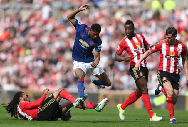 Marcus Rashford is tackled by Jason Denayer