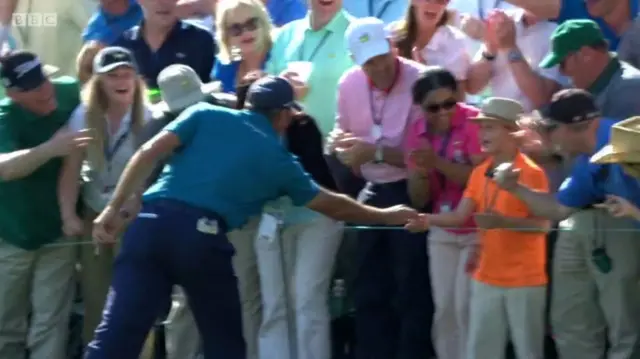 Matt Kuchar gives ball to young fan