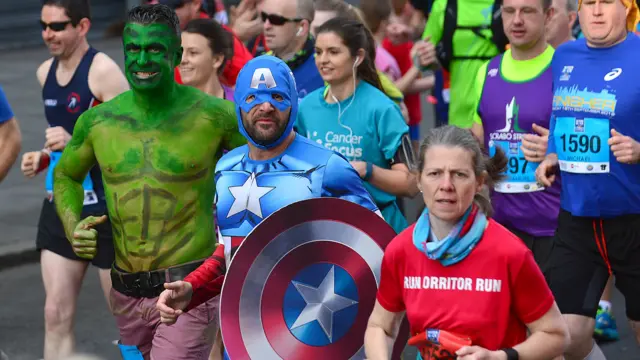 Runners wearing superhero costumes