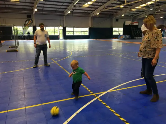 Benji playing football with his parents at the FA People's Cup finals in Birmingham