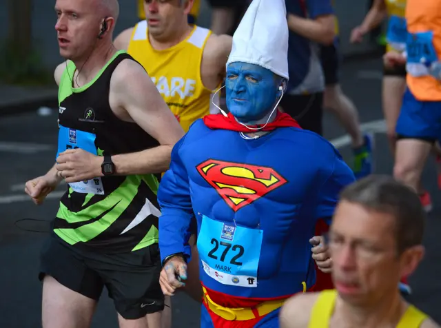 A runner wearing a Superman costume