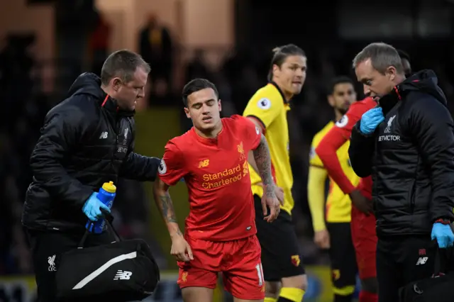 Liverpool"s Philippe Coutinho receives medical attention