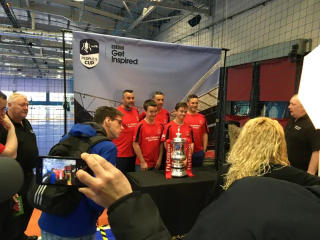 Fans having their photos taken with the FA Cup at the FA People's Cup finals in Birmingham