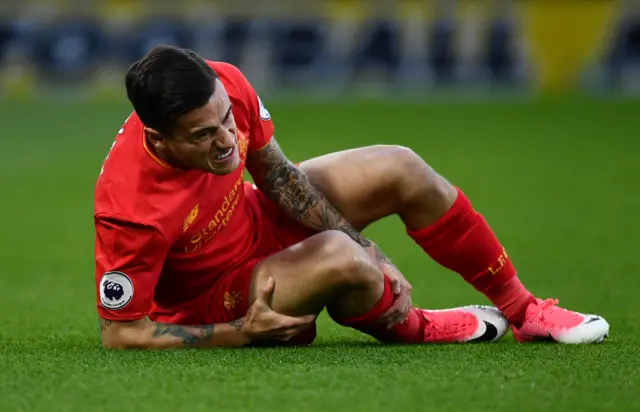 Philippe Coutinho of Liverpool goes down injured