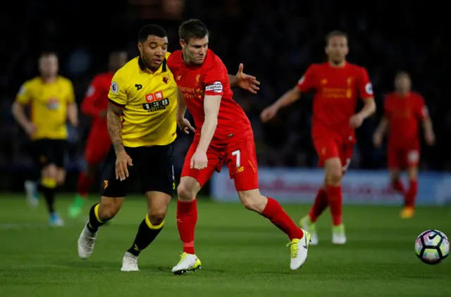 Troy Deeney in action with Liverpool"s James Milner