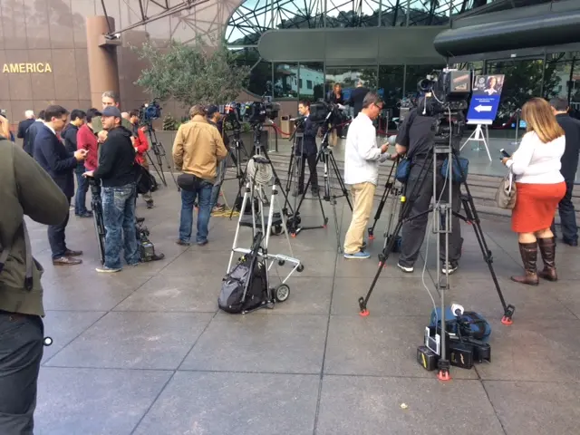 Reporters outside the event Comey is meant to attend