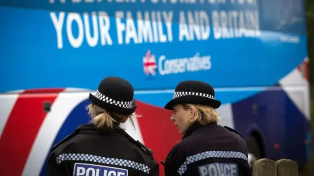 Police and Conservative Battle Bus