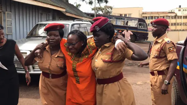 Stella Nyanzi supported by two police officers