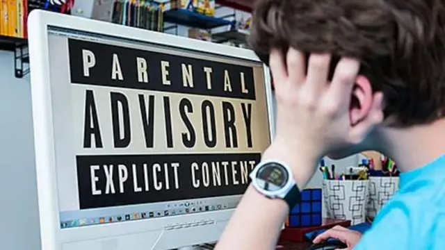 Child in front of computer with parental advisory sign