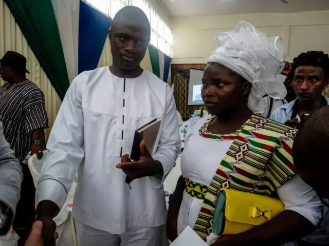 Evangelical preacher Emmanuel Momoh arrives with his wife on May 11, 2017 in Freetown for the auction of the 709 carats diamond he found earlier this year