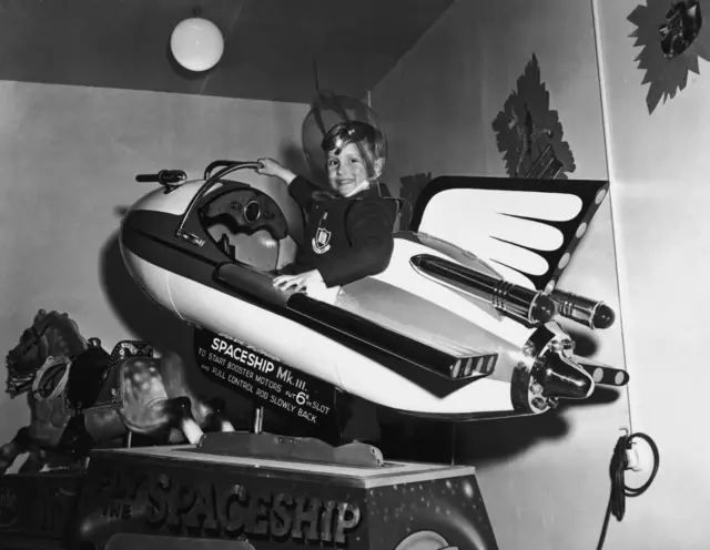 Balck and white photo of young boy in spaceship