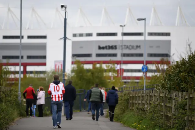 Stoke City fan walks towards the Bet365 Stadium