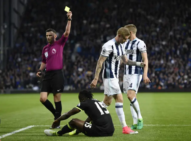 James McClean is shown a yellow card