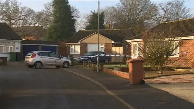 Police vehicle outside bungalows