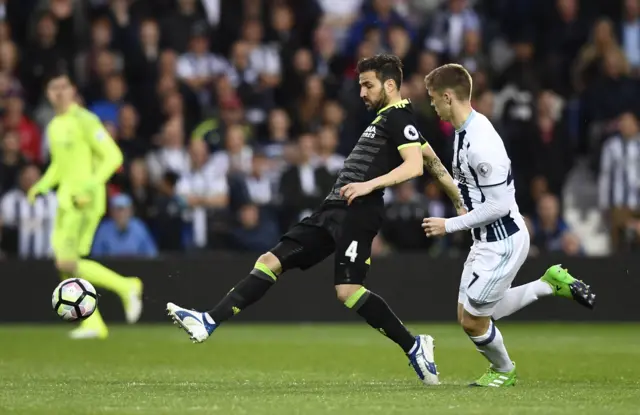 Cesc Fabregas plays a pass